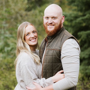 Man and woman embracing each other while smiling at camera